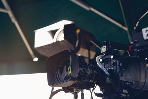 Professional cameras and lights set up outside 